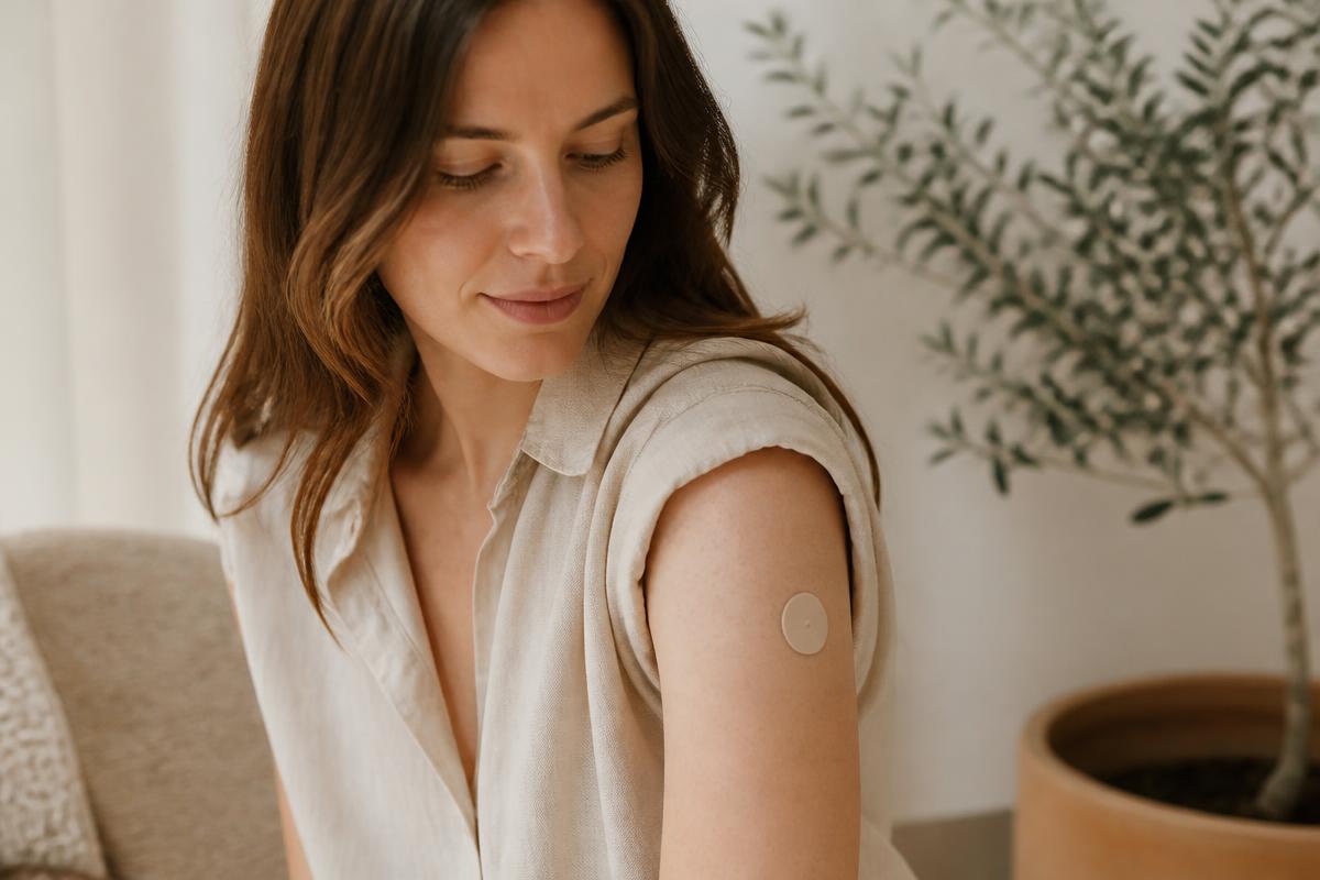 Woman wearing a wellness patch on her upper arm
